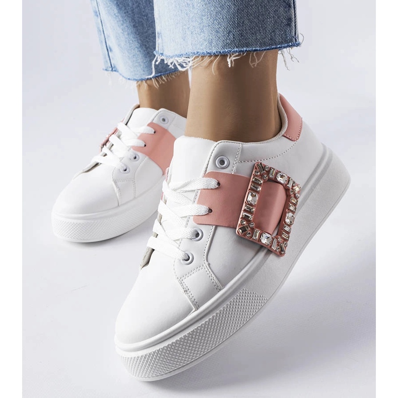 White sneakers decorated with a pink Ike buckle 1