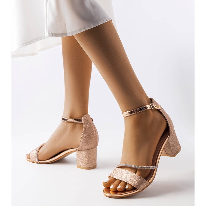 Shiny golden sandals on the post Lidia 1