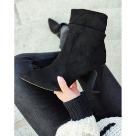 Ladies' black boots on a decorated post 2