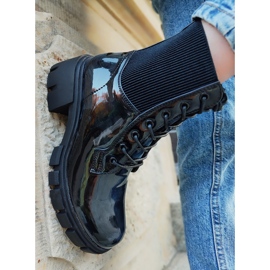 Lacquered black women's boots on the post 1