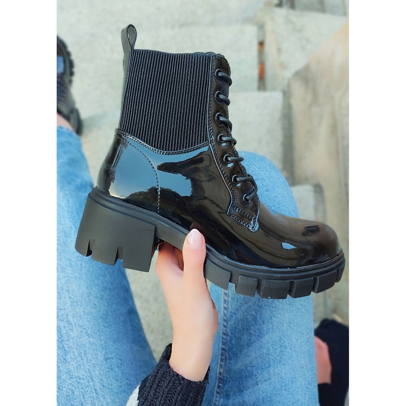 Lacquered black women's boots on the post 2