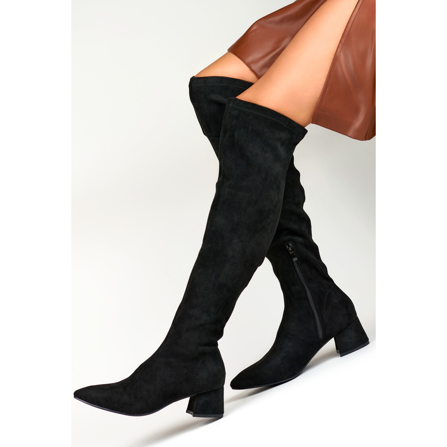Black suede boots above the knee with a low heel