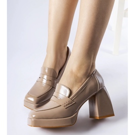 Beige patent pumps with a West heel 1