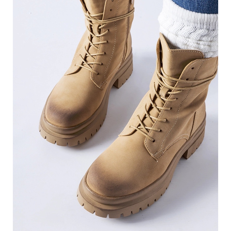 Beige boots with a worn toe from Vadnais 1