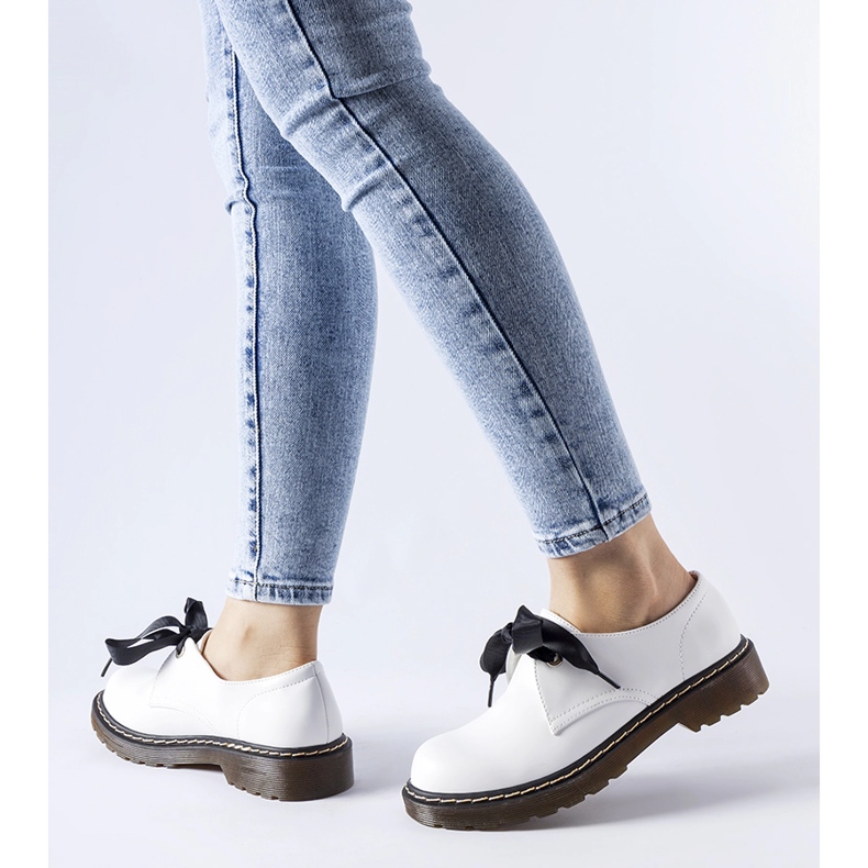 White shoes with a decorative bow from Rodriguez 1