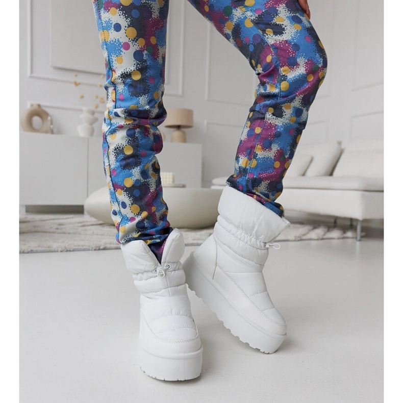 White insulated snow boots on the Polk platform 1