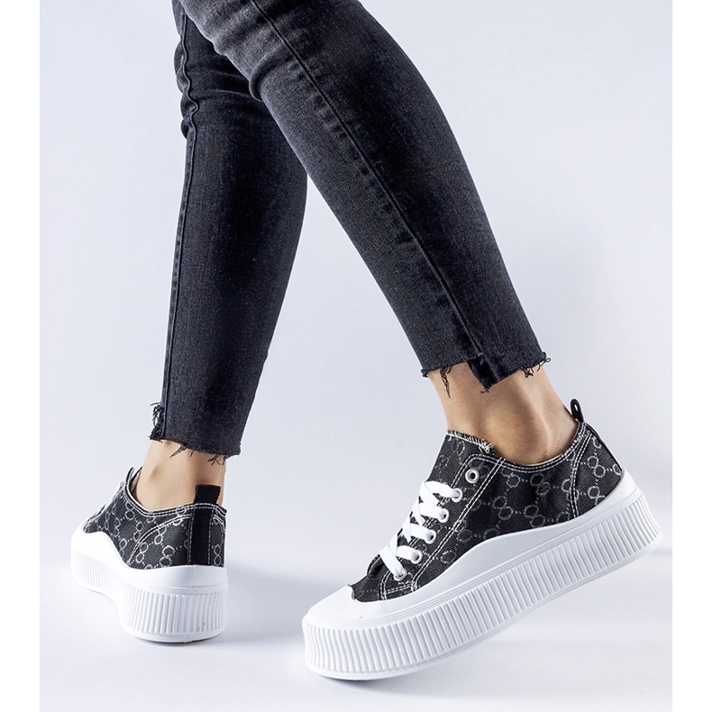 Black sneakers decorated with the Cavi monogram 1