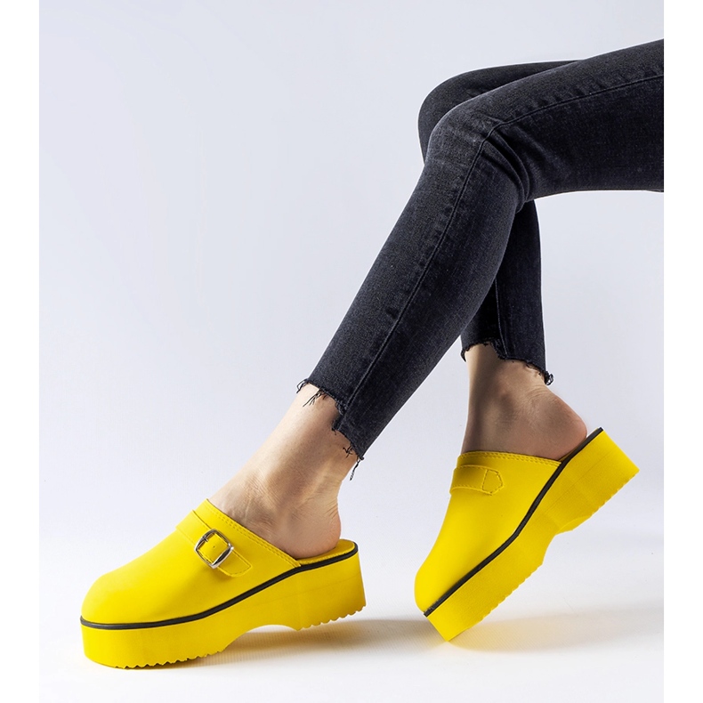 Yellow clog slides on the Lang platform 1