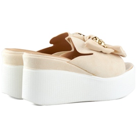 Beige women's slippers with a teddy bear and a bow on the wedge 1