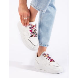 White women's sneakers tied with a ribbon 1