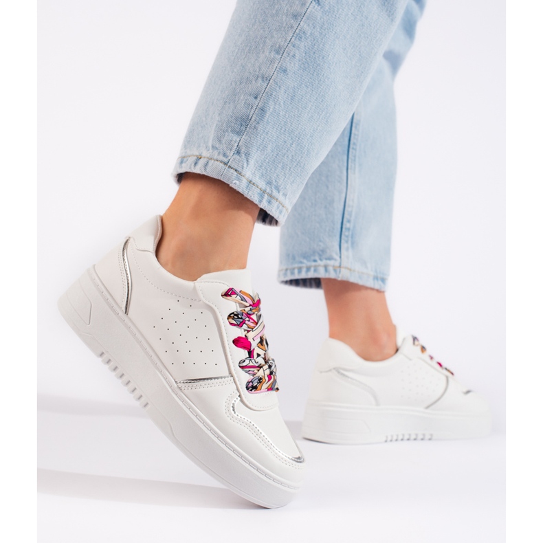 White women's sneakers tied with a ribbon 2