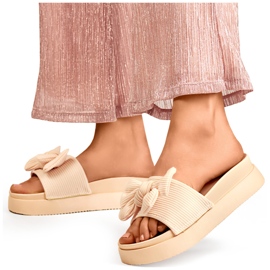 Beige women's slippers with a bow on a thick sole 1