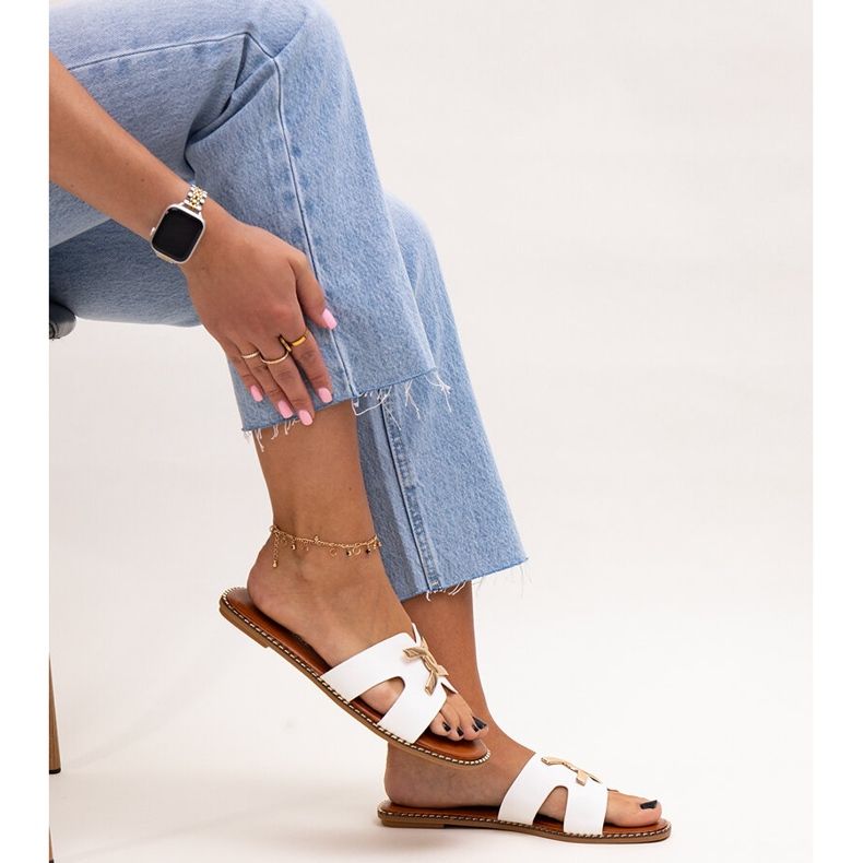 White flip-flops with a Razanna buckle 1