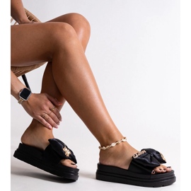 Black massive flip-flops with a bow and an Izsa teddy bear 1