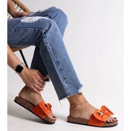 Orange flip-flops with a bow and a Segan teddy bear 1