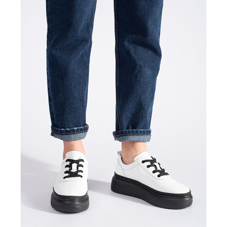 White leather shoes on a black platform 2