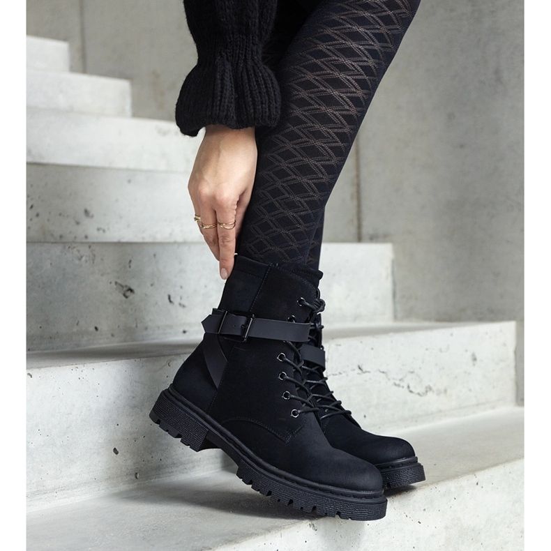 Black insulated hiking boots with abrasions and a Knees strap 2