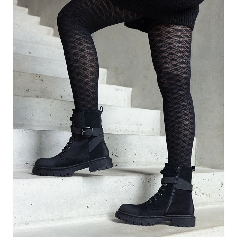 Black insulated hiking boots with abrasions and a Knees strap 1