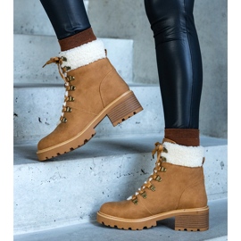 Brown lace-up boots decorated with a Moses sheepskin coat 1