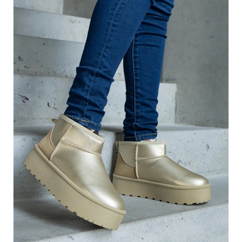 Golden low snow boots on the platform 1