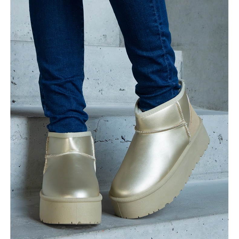 Golden low snow boots on the platform 2