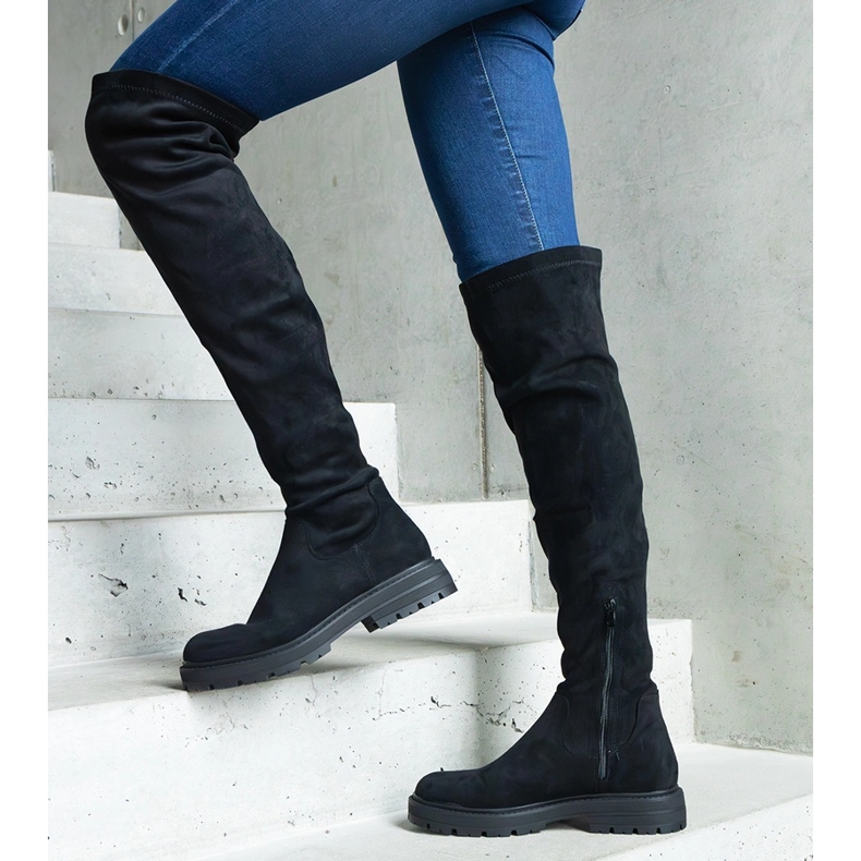 Black long boots with a flexible upper and a flat sole 1