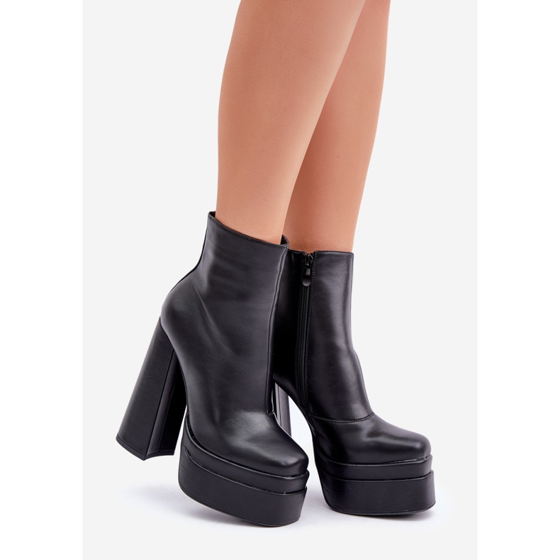 Insulated black ankle boots on a massive platform and high heel 1