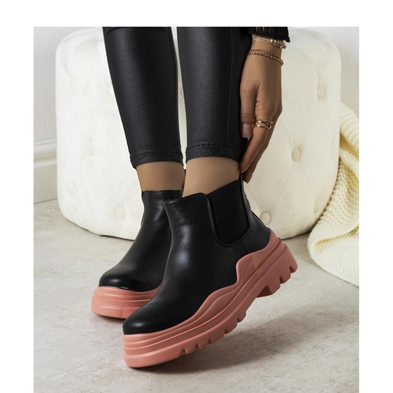 Black ankle boots on a pink platform 1