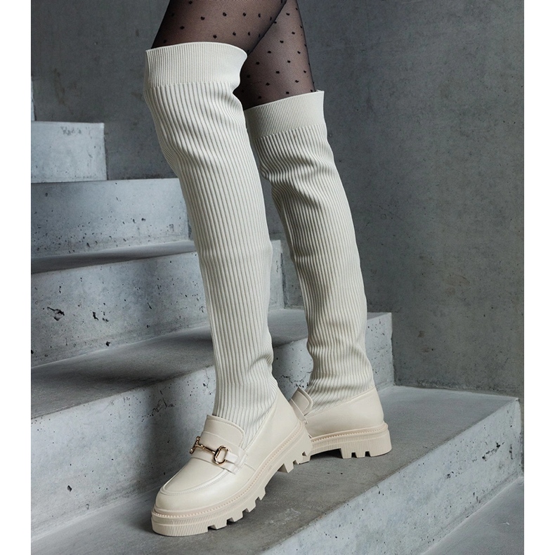 Light beige boots with a flexible upper and a flat heel 1
