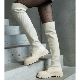 Light beige boots with a flexible upper and a flat heel 2