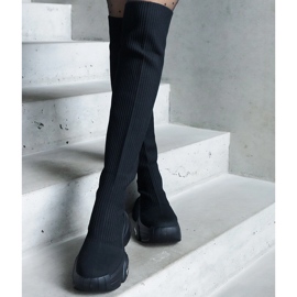 Black slip-on boots with a flexible upper and a massive sole 1