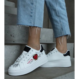 White sneakers decorated with a patch and inscriptions on the platform 2