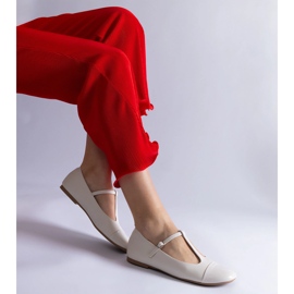 White ballet flats with a patent toe and fastened with a buckle 1