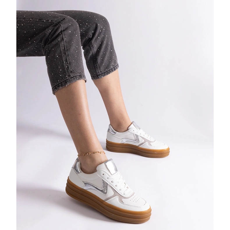 White and silver sneakers with a rubber sole 2