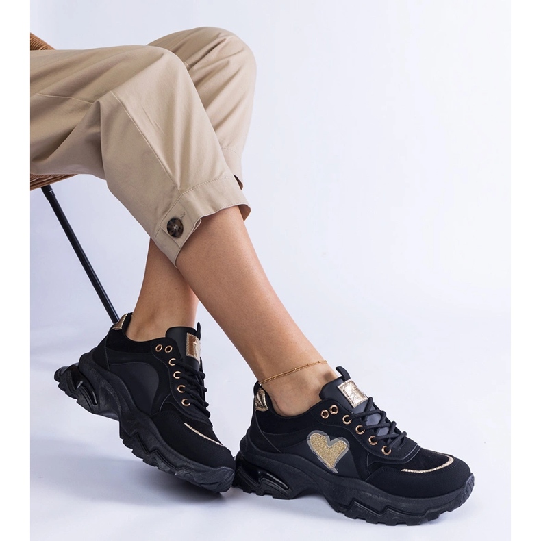 Black sneakers on a black heart platform 1