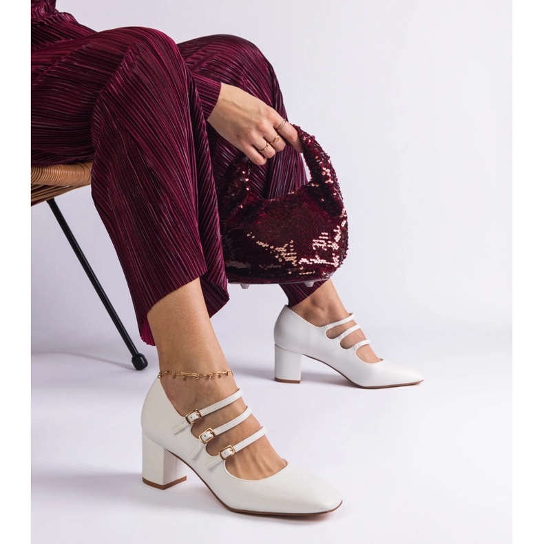 White high-heeled pumps with decorative buckles 1