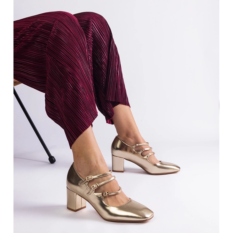 Golden pumps on the post with decorative buckles 1 Golden pumps on the post with decorative buckles 1