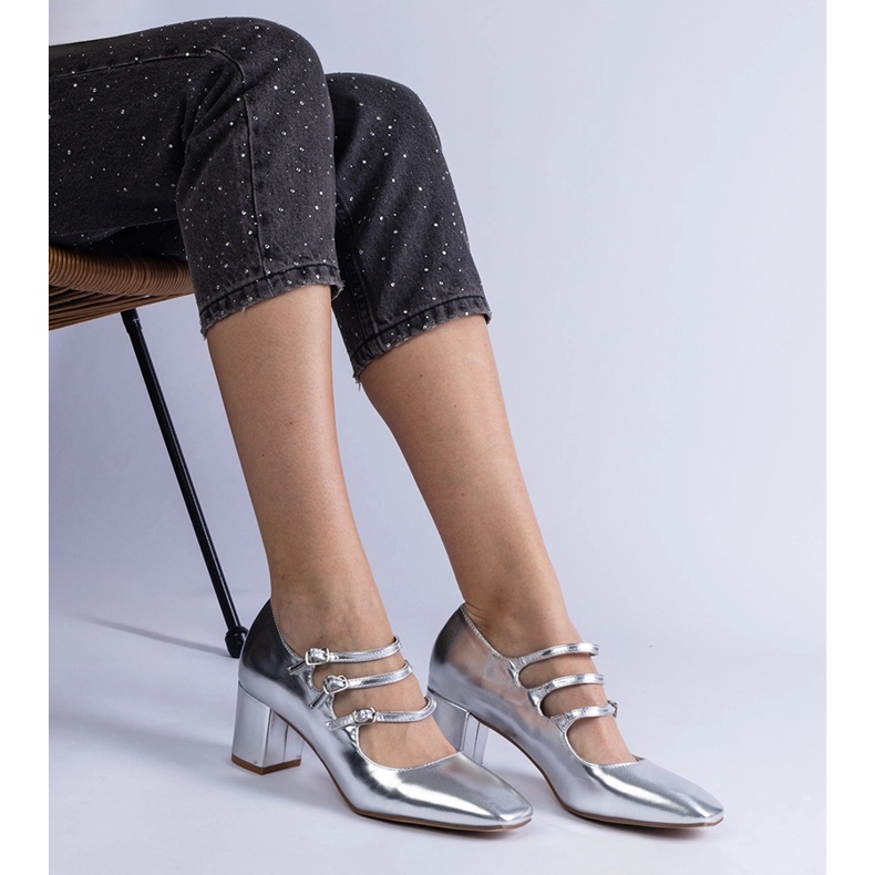 Silver pumps on a post with decorative metallic buckles 1
