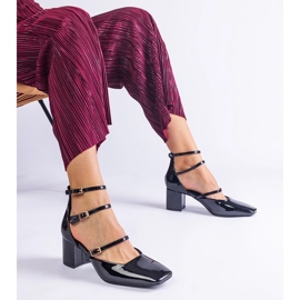 Black pumps varnished on a post with buckles 1