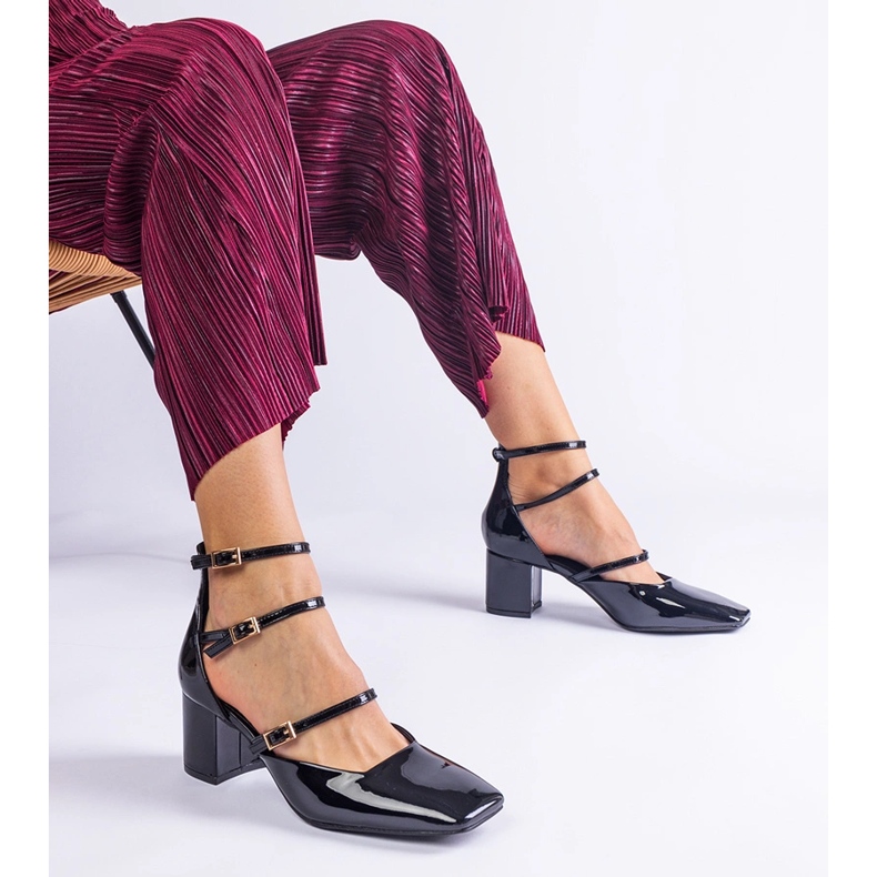 Black pumps varnished on a post with buckles 1