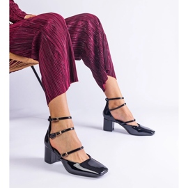 Black pumps varnished on a post with buckles 2