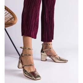 Golden pumps varnished on a post with buckles 1