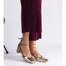 Golden pumps varnished on a post with buckles 2