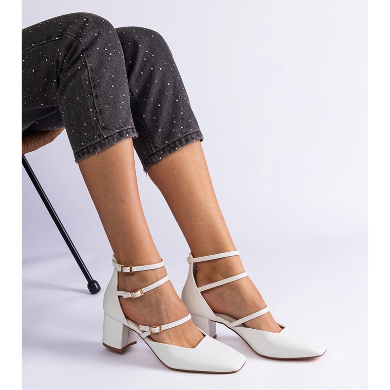 White pumps on the pillar with buckles 1
