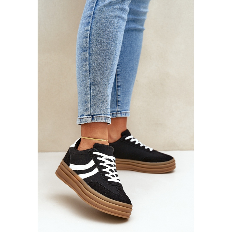 Stylish sneakers on the black and white platform 2