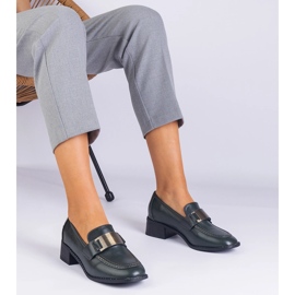 Green shoes on a low post with a metallic decoration 1