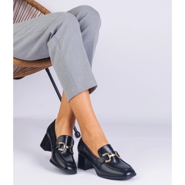 Black pumps on the post with a metallic decoration 1