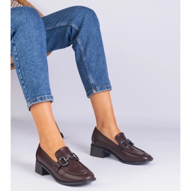 Brown pumps on a post with a metallic decoration 1