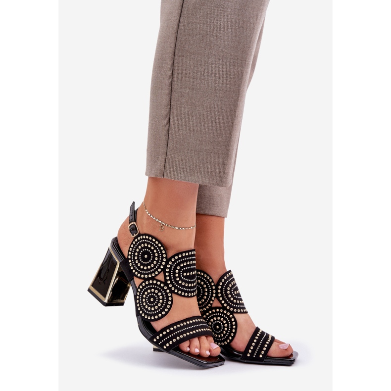 Decorated sandals on the black post 1