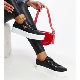 Black leather sneakers on the thick sole of Mikka 1